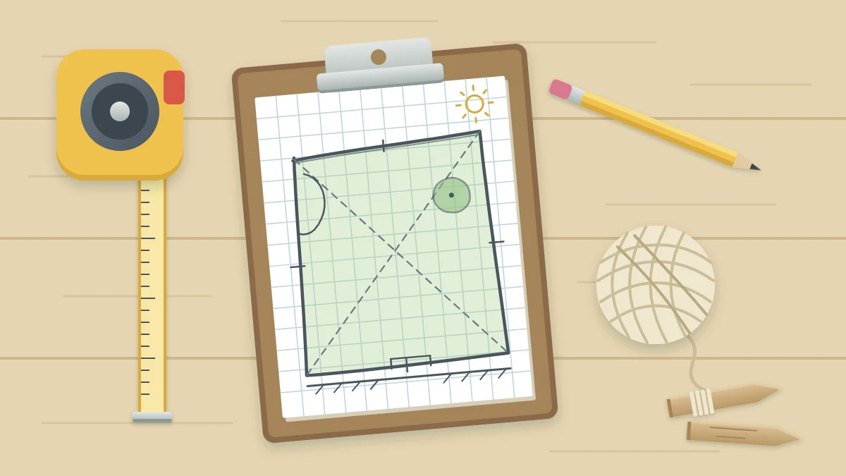 A clipboard with grid paper showing a hand-drawn garden outline, beside a tape measure, a pencil and a ball of string with two wooden pegs