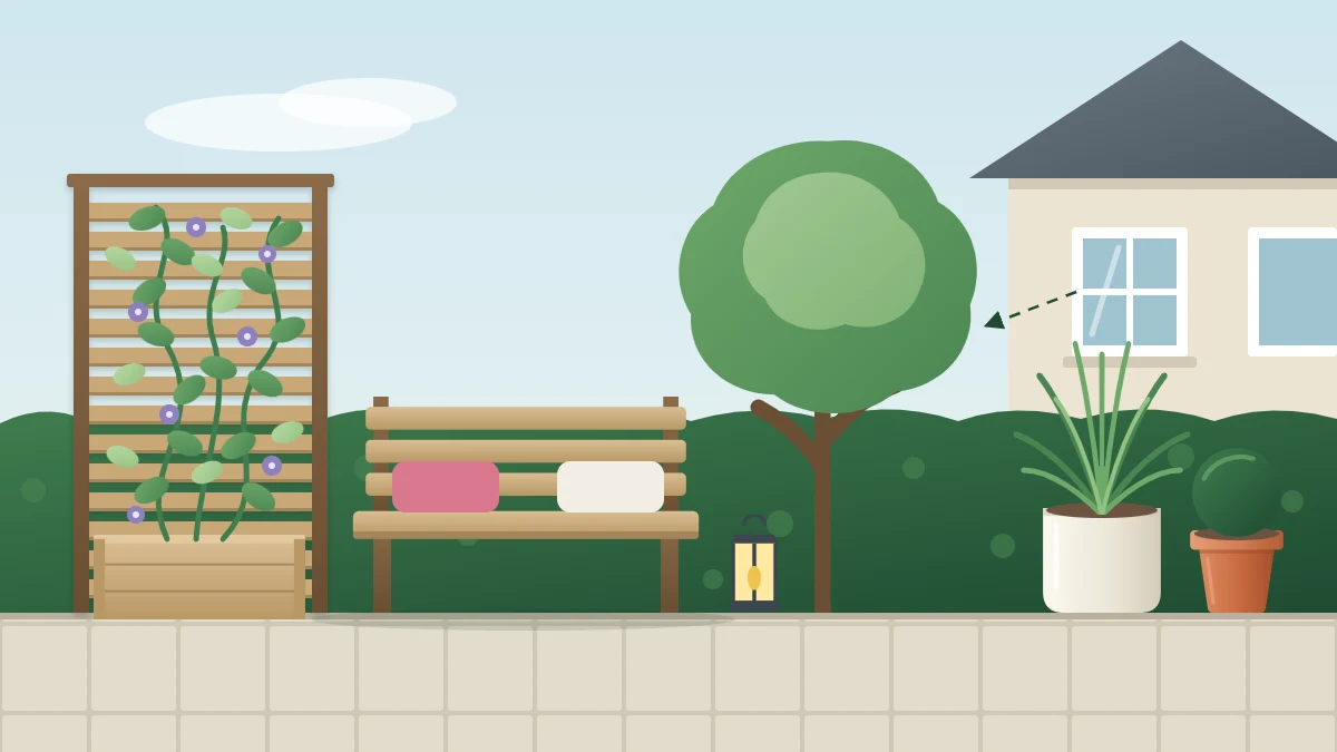 Small seating area screened by a slatted wooden panel with a climber and a small tree whose canopy blocks a neighboring upstairs window